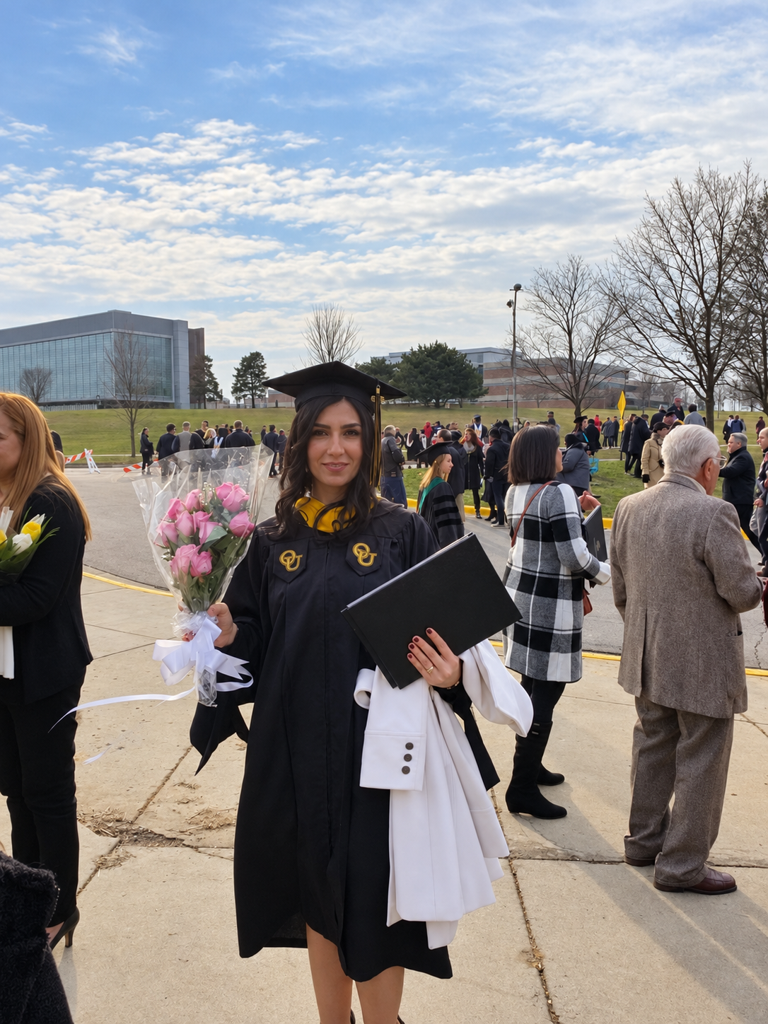 Hanan celebrating graduation at Oakland University